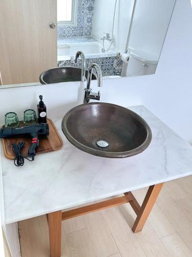 a bathroom counter with a sink and two mirrors at Costa Beach Residence & Jacuzzi in Sattahip