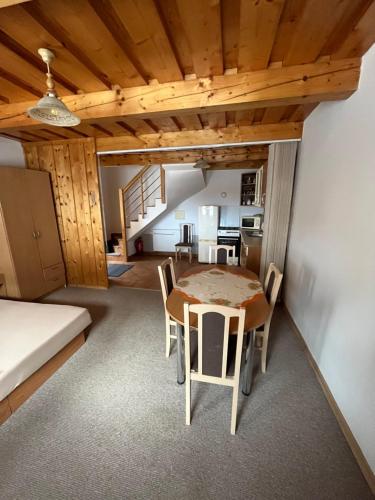 a kitchen and dining room with a table and chairs at Apartmány Bistár in Zuberec