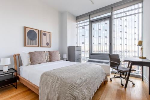 a bedroom with a bed and a desk with a chair at Blueground Midtown W gym nr hells kitchen NYC-1426 in New York