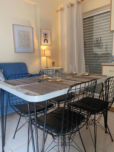 a dining room table with four chairs and a table and chairsktop at Apartment Elisabeth in Kanali