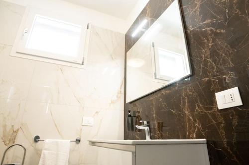 uma casa de banho com um lavatório e um espelho em [Da Lorenzo] - between station and center em Monza