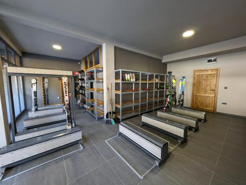 a gym with rows of benches in a room at BratSki Apartman - 200m od gondole in Brzeće