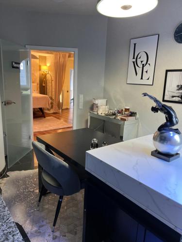 a kitchen with a table and a vase on a counter at SkinSpa Apartments Idar-Oberstein in Idar-Oberstein