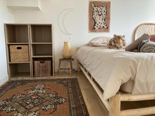 een slaapkamer met een bed en een tapijt bij St Malo à 15 Min et 10 Min de Dinard in Pleurtuit