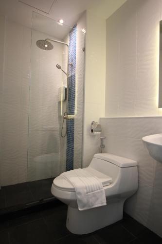 a bathroom with a shower and a toilet and a sink at Kamala Havana in Kamala Beach