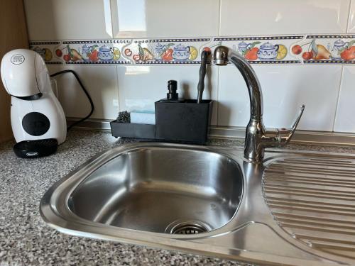 a kitchen sink with a faucet on a counter at La Biznaga de María in Torre del Mar