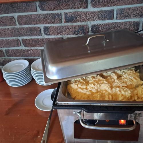 a pan of food is cooking in an oven at Penzion Diana in Kunžak