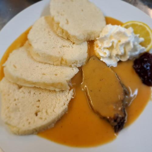 a plate of food with bread and ice cream at Penzion Diana in Kunžak