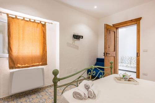 a bedroom with a bed and a window at Terrazza e Conchiglie in Torre Suda
