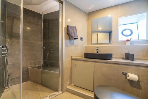 a bathroom with a shower and a sink and a glass shower stall at Explorer Yacht in Fethiye