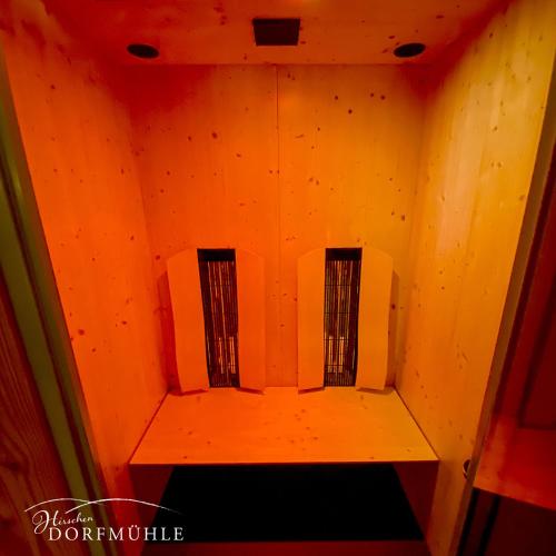 an orange room with two microwaves in it at Hirschen-Dorfmühle in Biederbach Baden-Württemberg