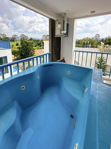a blue bath tub sitting on top of a balcony at Costa Beach Residence & Jacuzzi in Sattahip