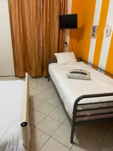 a bedroom with a bed and a baseball bat at Igoumenitsa heart flats to let Mariasroom studios appart seaside-city Spyropoulos in Igoumenitsa