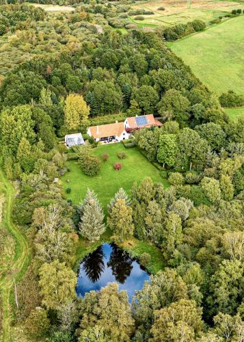 an aerial view of a house with a pond at Stoksholmene13 in Svebølle