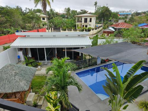 an aerial view of a house with a swimming pool at Palm View Moalboal in Moalboal