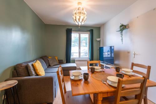 un salon avec un canapé et une table dans l'établissement F2 coloré et confortable proche Disney+WIFI, à Bailly-Romainvilliers