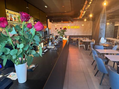 a restaurant with tables and flowers on the counter at Dazio Exclusive Rooms in Rome