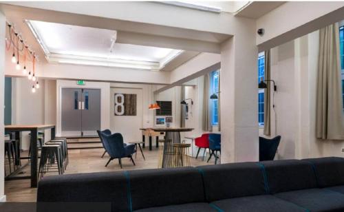 a living room with a couch and chairs and tables at Frances Gardner in London