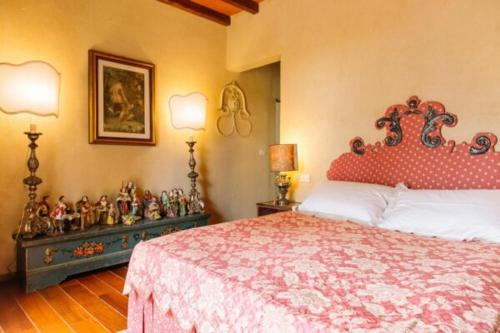 a bedroom with a large bed with a red head board at La Sergiunga del Monferrato in Casorzo