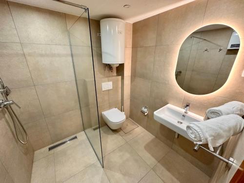 a bathroom with a shower and a toilet and a sink at Glamping Tent Water Village Rogla in Oplotnica