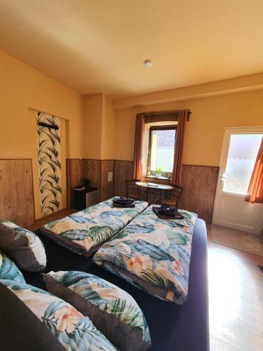 a bedroom with two beds and a window at Panzio A mi Paradicsomunk in Véménd