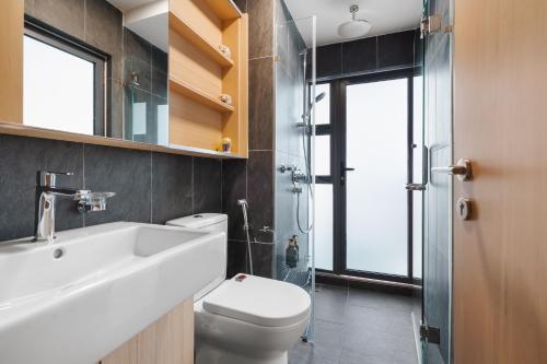 a bathroom with a toilet and a sink and a shower at Colony by Infinitum - 10mins to LRT Station in Kuala Lumpur