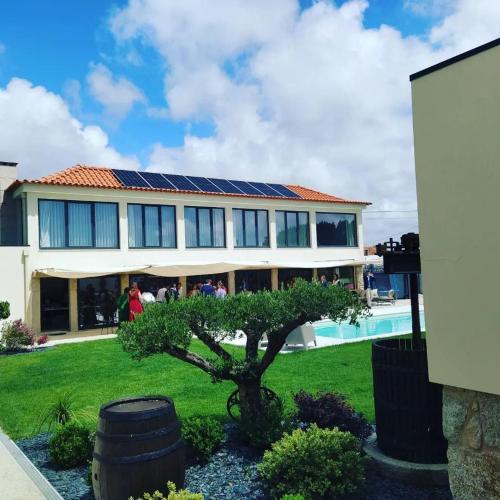 a house with solar panels on the roof at Celeiro do Carvalho in Estela