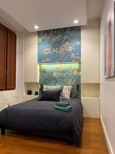 a bedroom with a large bed with a painting on the wall at Stunning apartment in the center of Lyon ! in Lyon