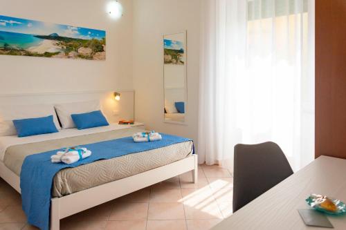 1 dormitorio con 1 cama con toallas en Casa Mian - Bed and Breakfast, en Orosei