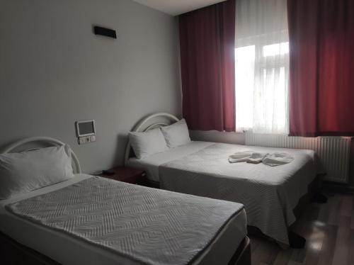 a hotel room with two beds and a window at YASİN OTEL in Konya