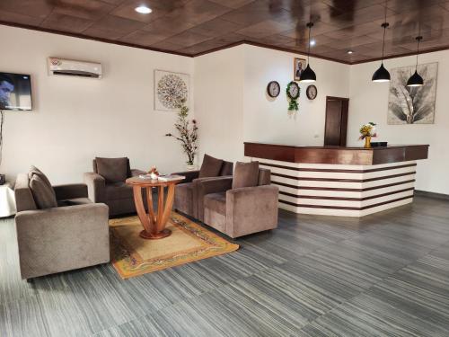 a lobby with couches and a counter in a building at HOTEL DE L'OCEAN KRIBI in Kribi