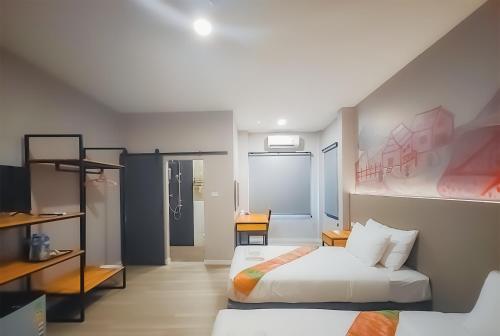 a hotel room with two beds and a room with at The Riva Vientiane Hotel in Vientiane