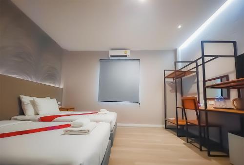 a room with two beds and a ladder at The Riva Vientiane Hotel in Vientiane