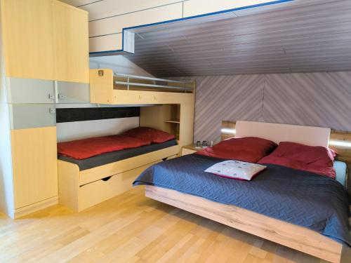 a bedroom with two bunk beds with red pillows at Bauernhof Sonnenhuab in Sankt Veit im Pongau