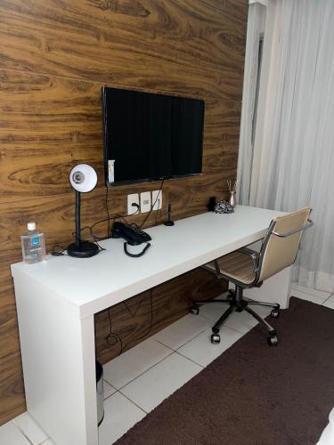 a white desk with a computer monitor and a chair at Hotel Vision in Brasilia
