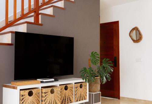 a living room with a large flat screen tv at Meraki in Playa Blanca