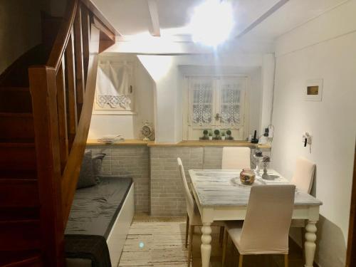 a kitchen with a table and chairs in a room at Grandma’s old town house in Corfu Town