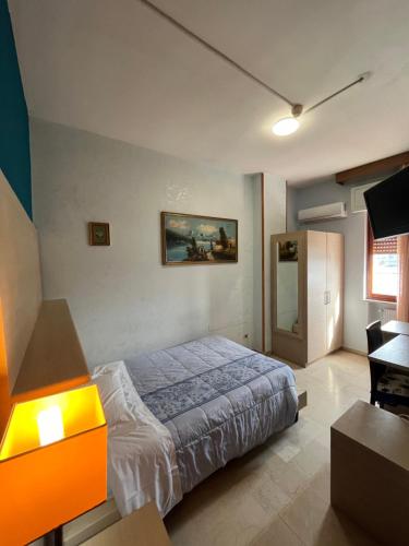 a bedroom with a bed and a desk in it at Hotel L'Approdo in Brindisi