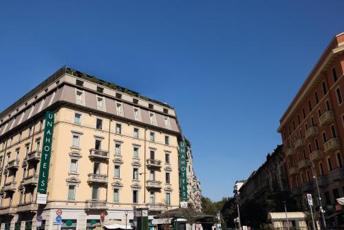 a tall white building on a city street at UNA Hotels Galles Milano in Milan
