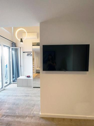 a large flat screen tv on the wall of a room at Art Studios Gialova Navarino in Gialova