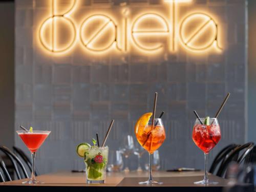 a group of four cocktails sitting on a table at ibis Valence Sud in Valence