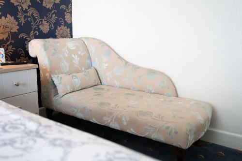 a chair in a room with a pillow on it at The Ship Inn in Holy Island