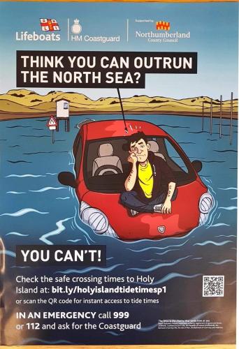 a poster of a man in a car in the water at The Ship Inn in Holy Island