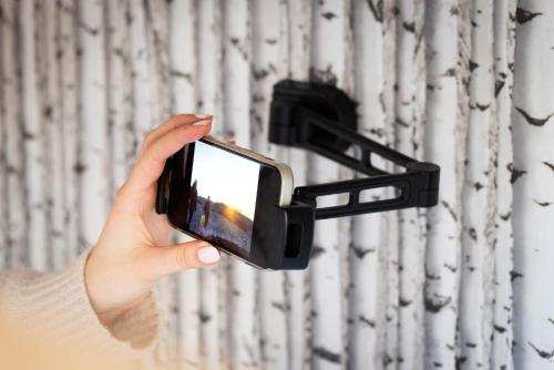 a person holding a cell phone in a holder at Slottsskogens Hostel in Gothenburg