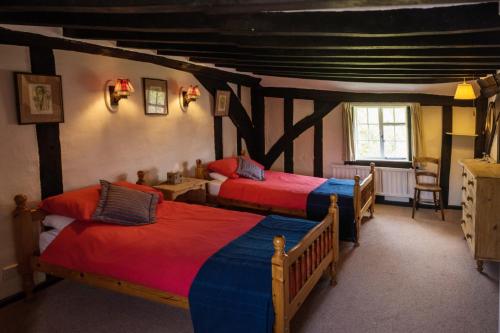 a bedroom with two beds in a room at Toad Hall in Swilland