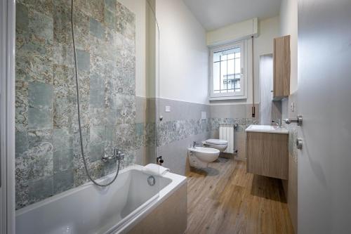 a bathroom with a bath tub and a toilet at YID Pietrafitta in Florence