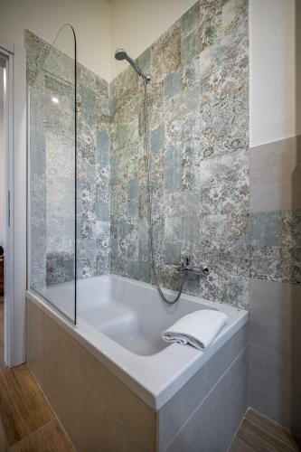 a bath tub in a bathroom with a shower at YID Pietrafitta in Florence