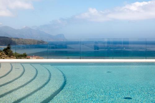 a swimming pool with a view of the water at La Blanca Resort & Spa in Castellammare del Golfo