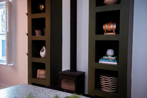 a fireplace in a room with a stove at Hygge House in Robertson
