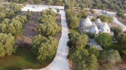 an aerial view of a house with trees and a road at Sopra i Sassi - Villa & Trulli in Ostuni